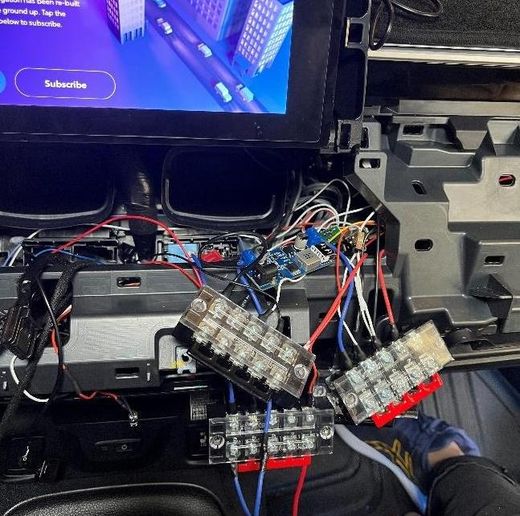 Open dashboard with barrier-strip terminal blocks and bundles of control wiring under the head unit